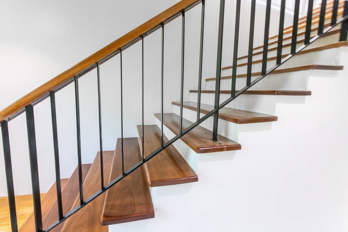 Side view modern wooden staircase with steel guard rail