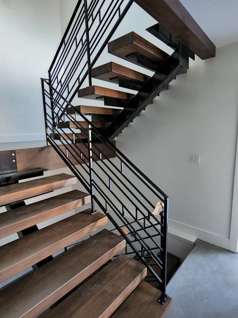 Modern floating staircase with dark wood steps and black metal geometric railing in minimalist interior