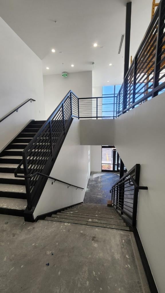 Modern interior stairwell with black metal stairs and railings